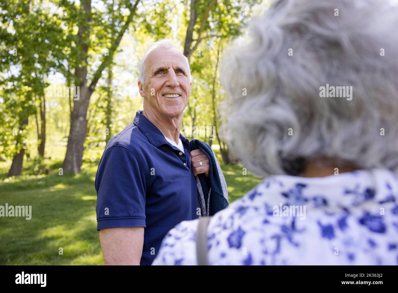 Portrait of cheerful senior man with wife in park Stock Photo
