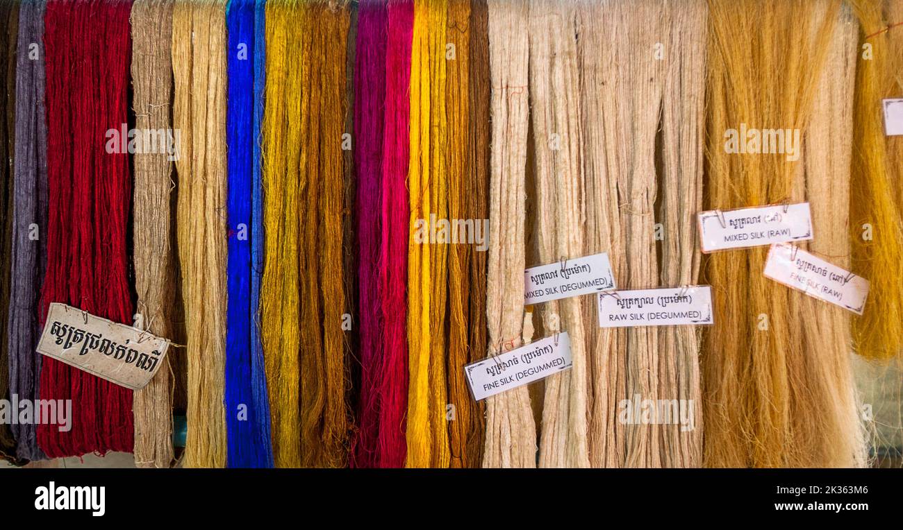 Dyed raw silk threads hanging for the tourist to see during the tour. Stock Photo