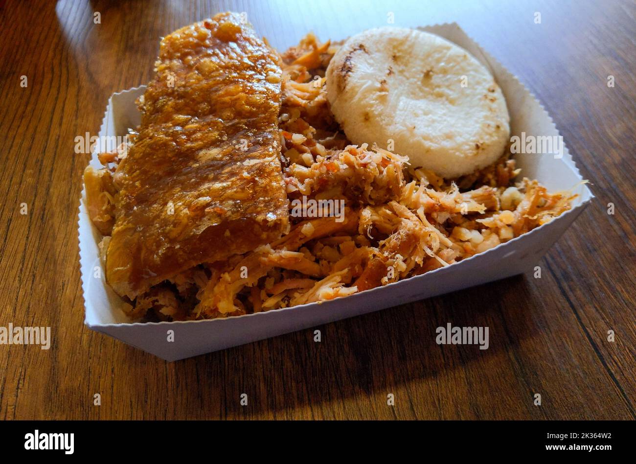 Lechona, a typical Colombian dish based on rice and pork and arepa. Stock Photo