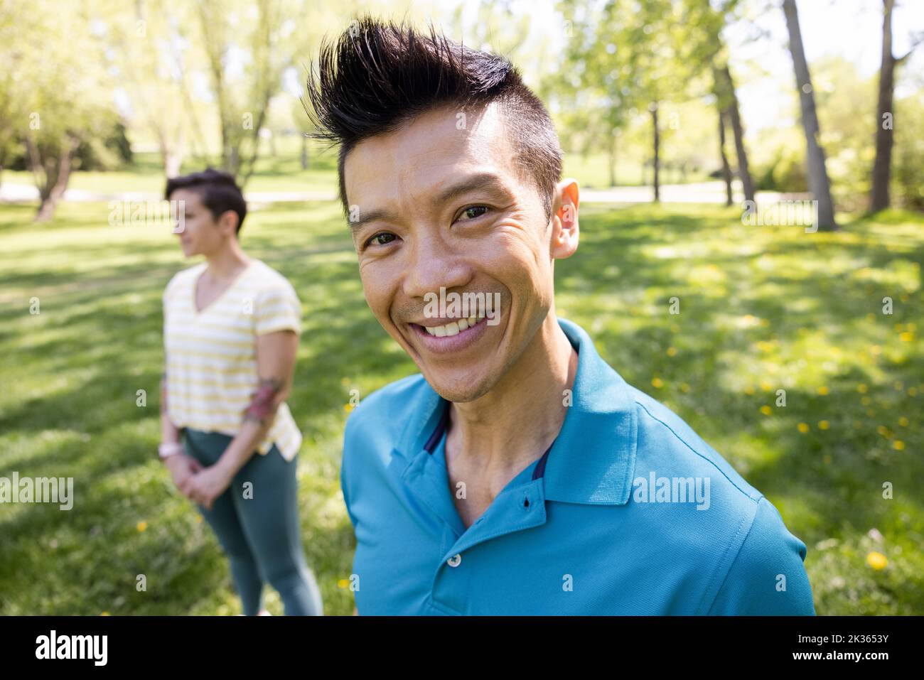 Portrait of cheerful man with wife in park Stock Photo