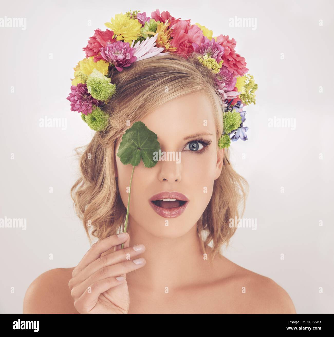 See beauty in a new light. A young woman with flowers in her hair