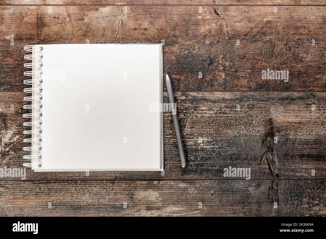 Blank notebook on vintage wooden table. mockup notebook on old rustic desk. Mockup blank notebook and pen on old rustic wooden table. top view. copy s Stock Photo
