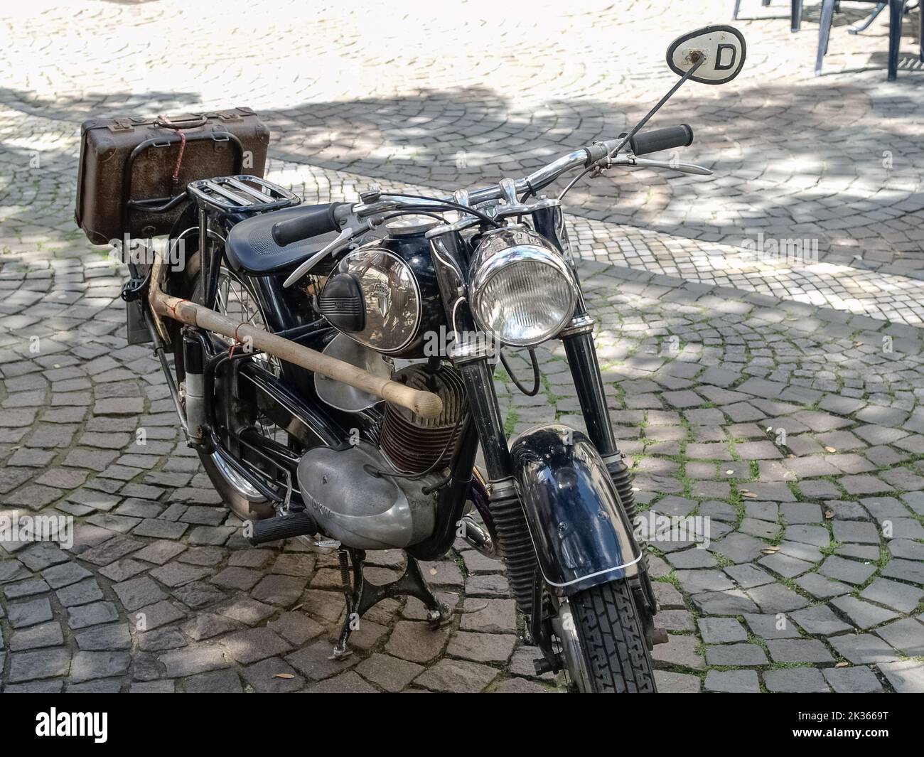 Auto Union DKW (Dampf-Kraft-Wagen) RT motorcycle oldtimer with leather suitcase and shovel standing in the old town of Linz am Rhein, Germany Stock Photo
