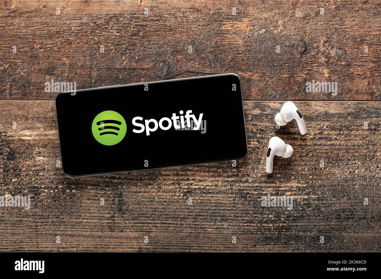 USA, NEW YORK September 22, 2022: Spotify logo mobile app on screen cellphone on old wooden table. Spotify music and audio streaming service. Spotify Stock Photo