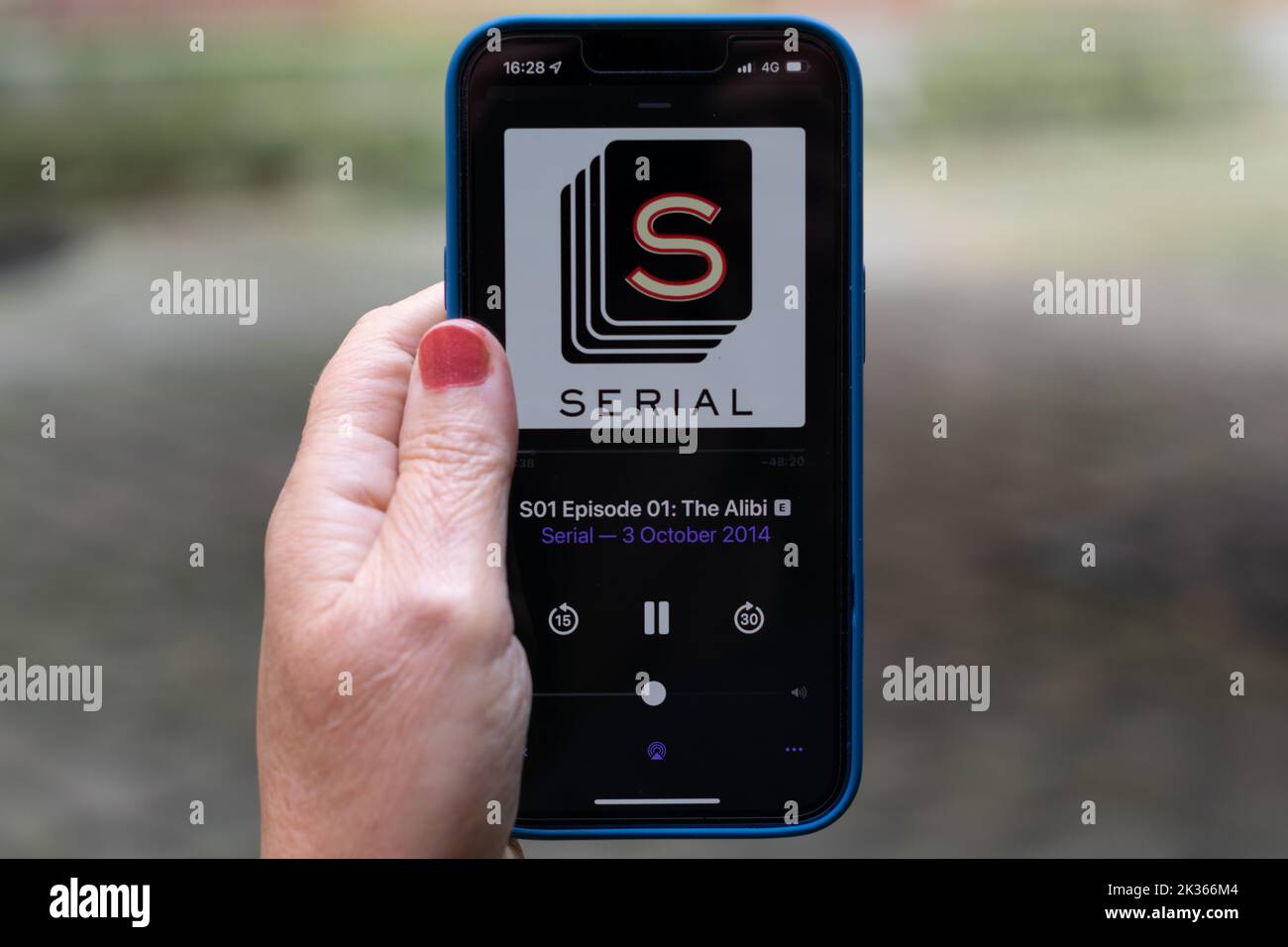 Listening to Serial podcast on iPhone. S01 Episode 01. Stock Photo
