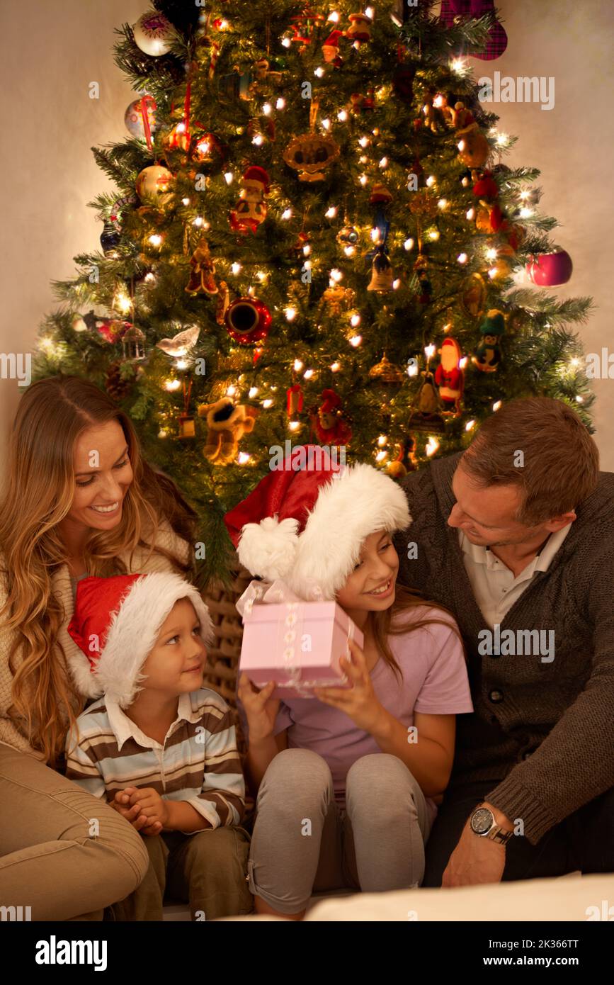 The gift of giving is priceless. A little girl receiving a Christmas