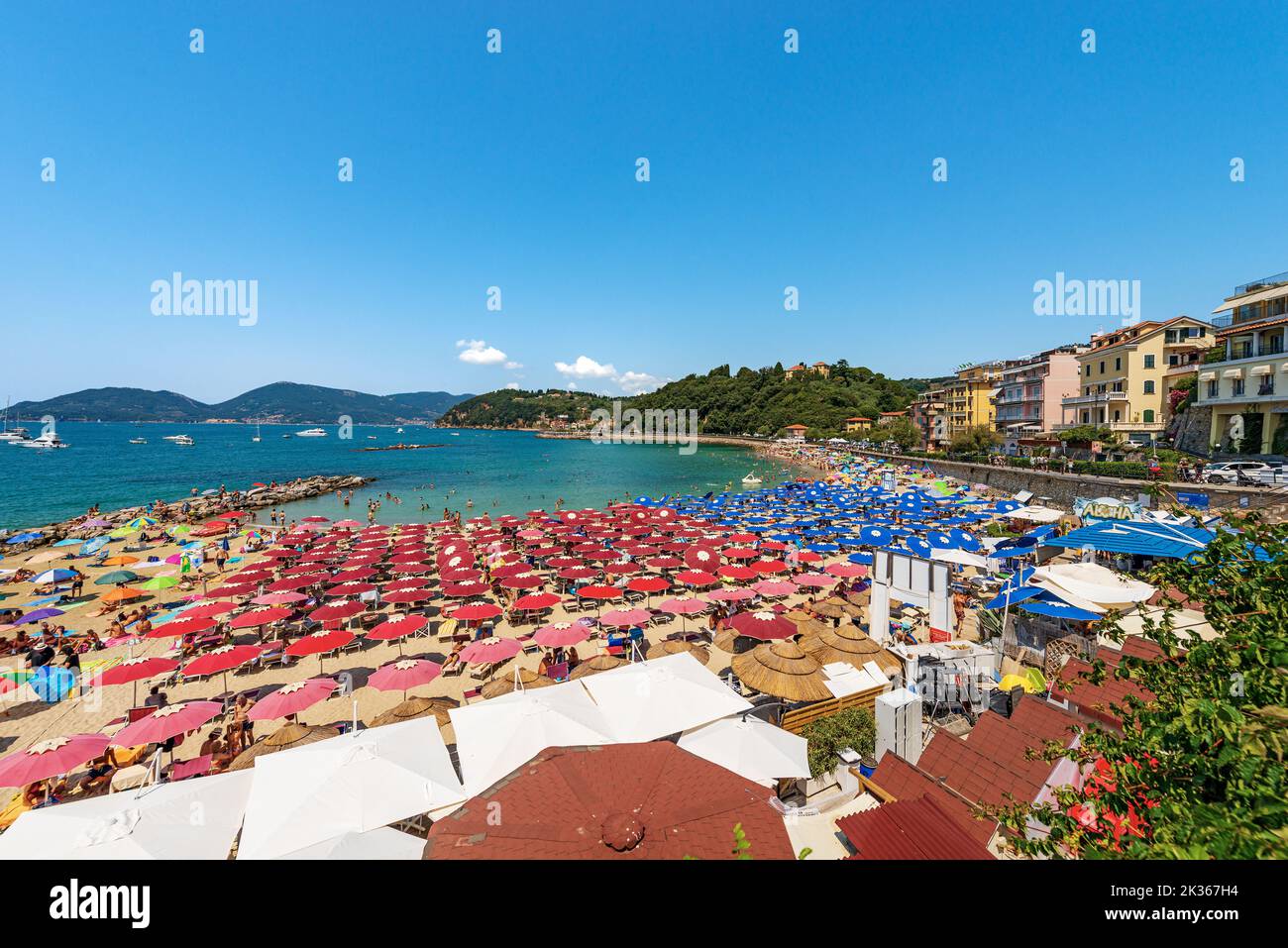 Beach of Lerici Town with many umbrellas, tourist resort on the coast of the Gulf of La Spezia, Liguria, Italy, Europe. Small village of San Terenzo. Stock Photo