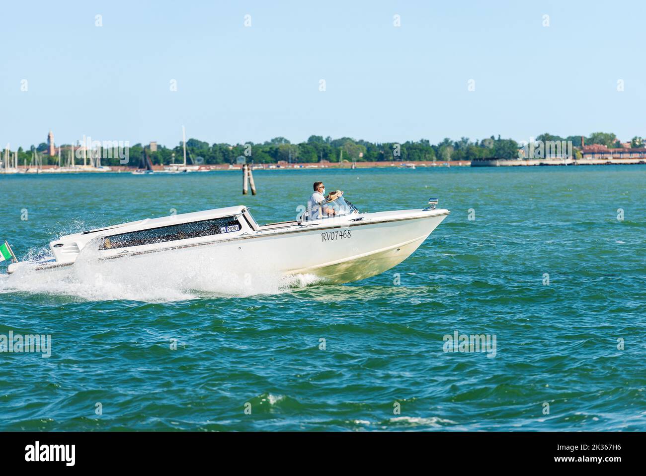 White water taxi in motion in the Venice lagoon driven by a man taxi driver. The fastest way to travel in this city. Venice, Italy, Veneto, Europe. Stock Photo