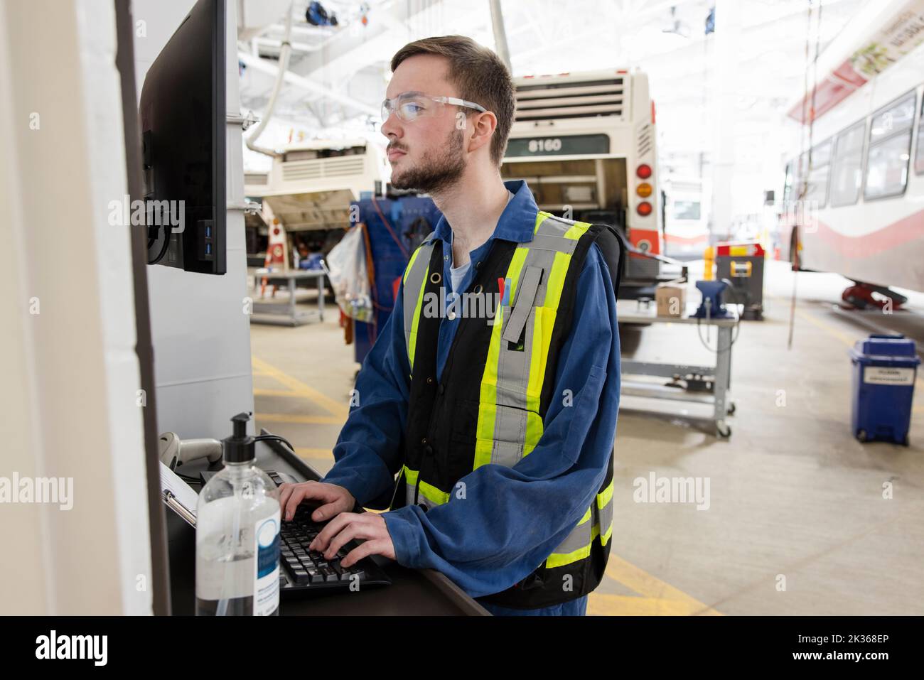 Male maintenance facility worker using computer Stock Photo Alamy