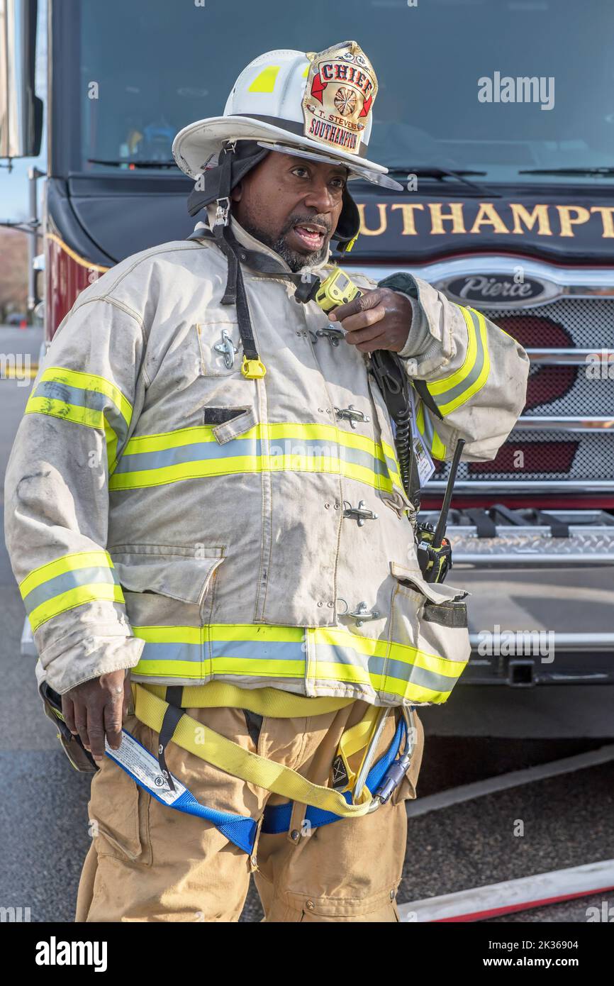 A fire chief issues commands on his portable radio as the Southampton Fire Department, assisted by units and members from the Bridgehampton, Sag Harbo Stock Photo