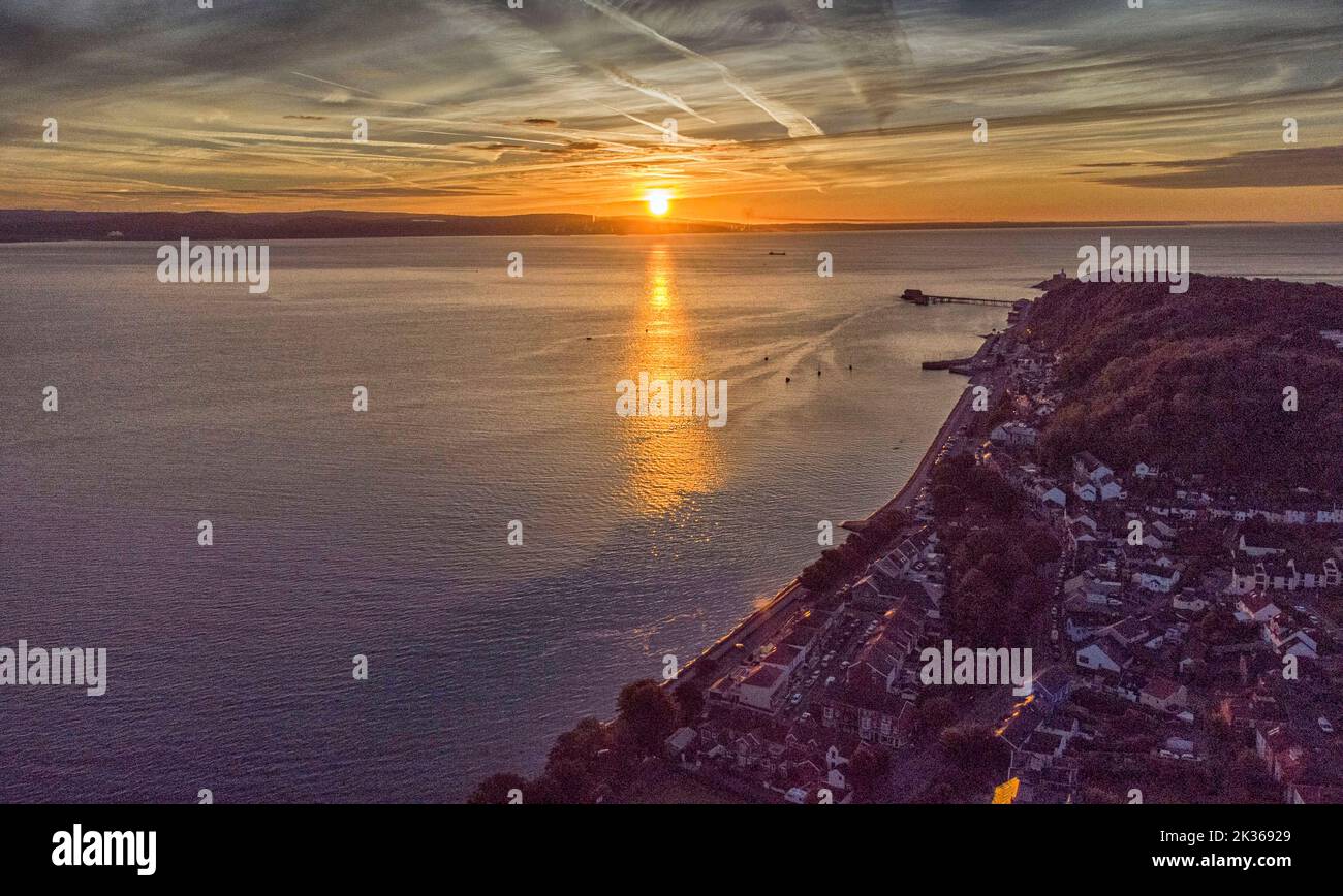 Swansea, UK. 25th Sep, 2022. The Autumn sun rises across the water from the small village of Mumbles, Swansea this morning at the start of the day. Credit: Phil Rees/Alamy Live News Stock Photo