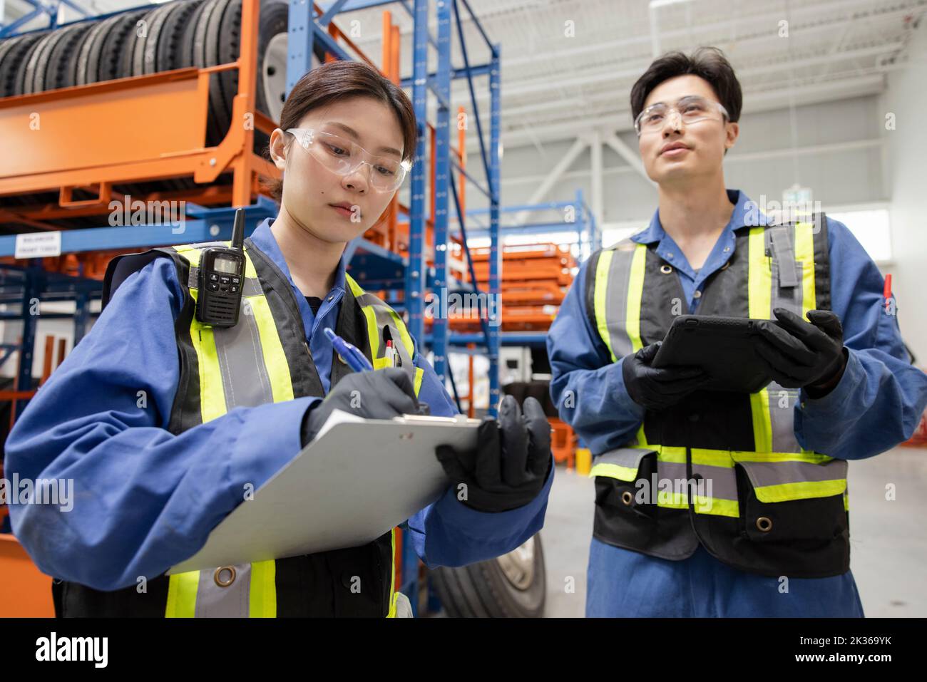 Workers with clipboard in maintenance facility Stock Photo Alamy