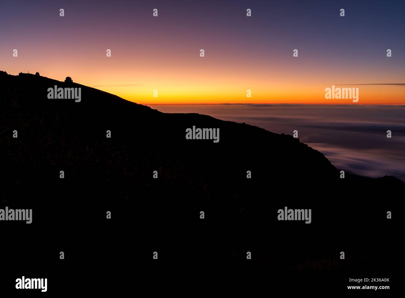 Long exposure of astronomical observatory over the mountain at sunset Stock Photo