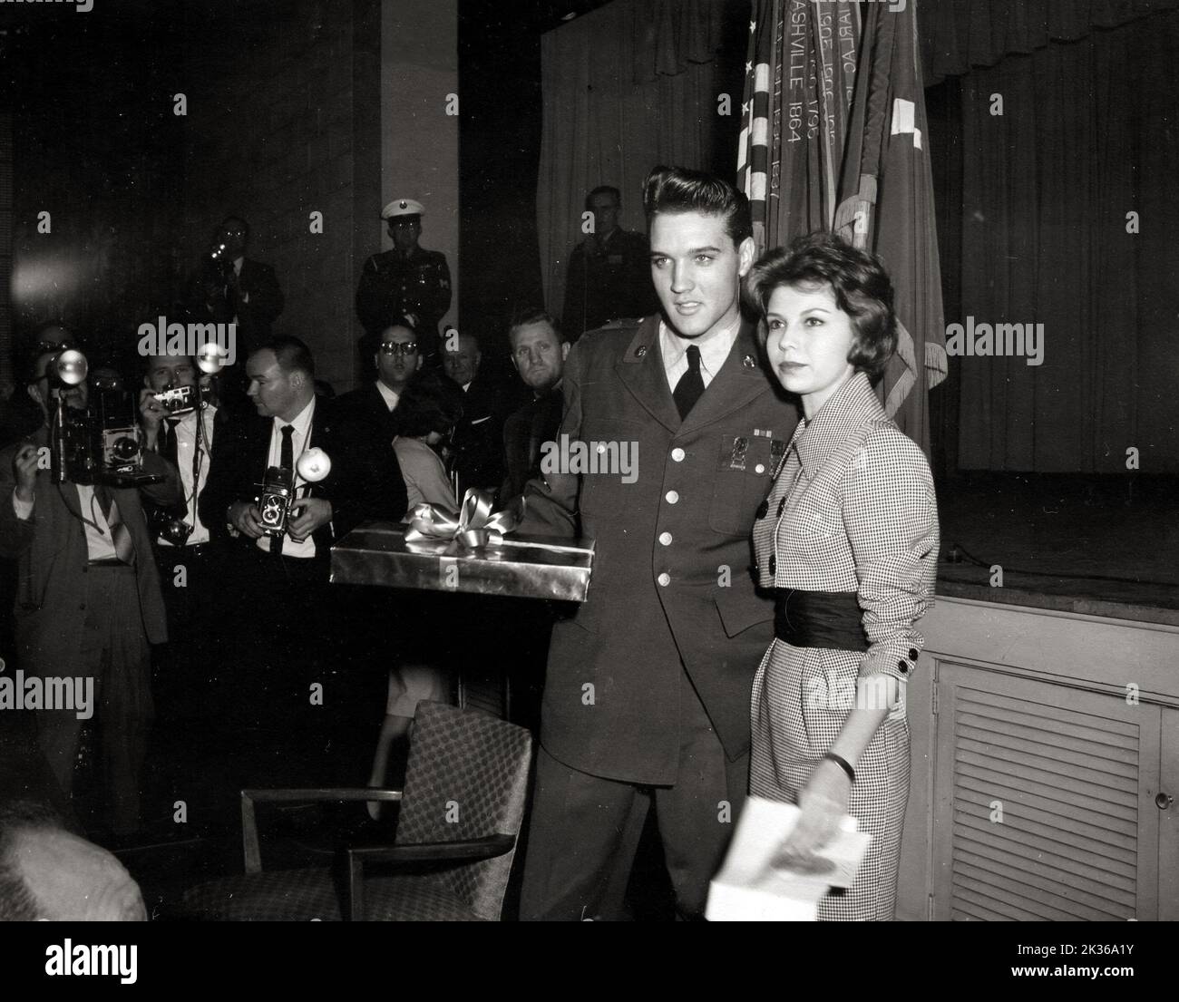 Sergeant Elvis Presley, Rock & Roll Singer, Receives a Gift From Miss Nancy Sinatra, Daughter of Frank Sinatra, at a Press Conference Held by Sergeant Presley in Service Club Stock Photo