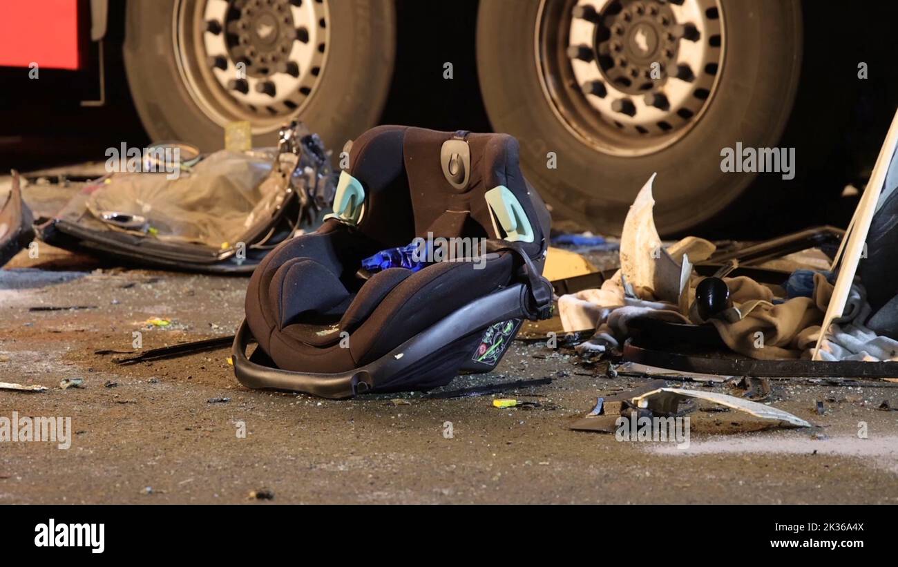 Bohmte, Germany. 25th Sep, 2022. A child's seat lies on the road next to two truck tires at the scene of the accident on federal highway 51 in the Osnabrück district. Four people were killed in a head-on collision between a car and a truck. According to the police, there were two adults and two small children in the car. Credit: Nord-West-Media TV/dpa/Alamy Live News Stock Photo