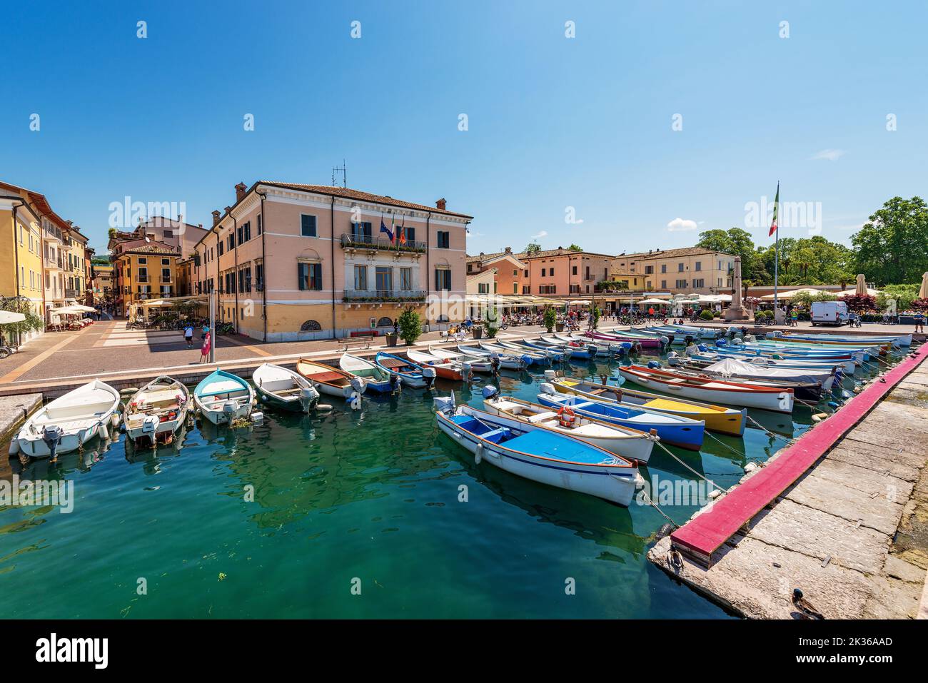 Small old port of the village of Bardolino with many boats moored. Tourist resort on the coast of Lake Garda. Verona province, Veneto, Italy, Europe. Stock Photo