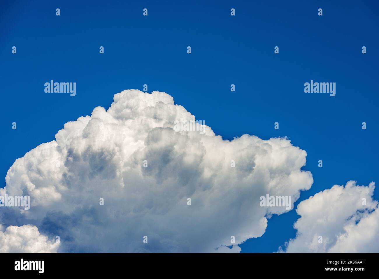 Photography of beautiful storm clouds, cumulus clouds or cumulonimbus against a clear blue sky. Full frame, sky only. Stock Photo