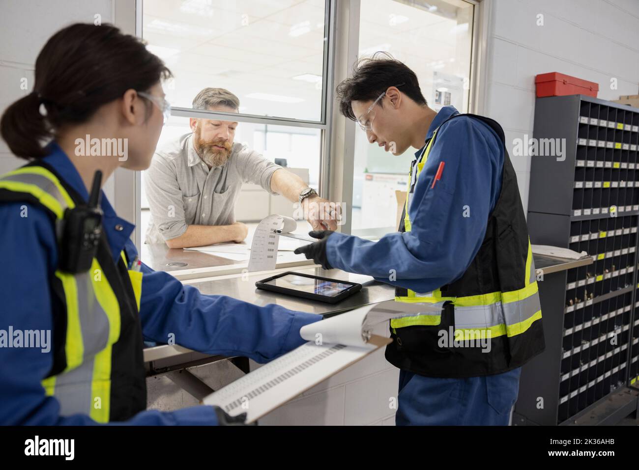 Supervisor talking with maintenance facility workers Stock Photo Alamy