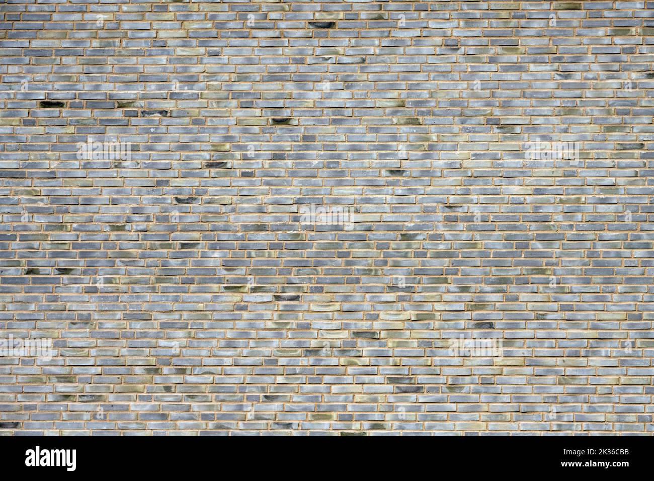 Background from a large wall made of gray bricks Stock Photo
