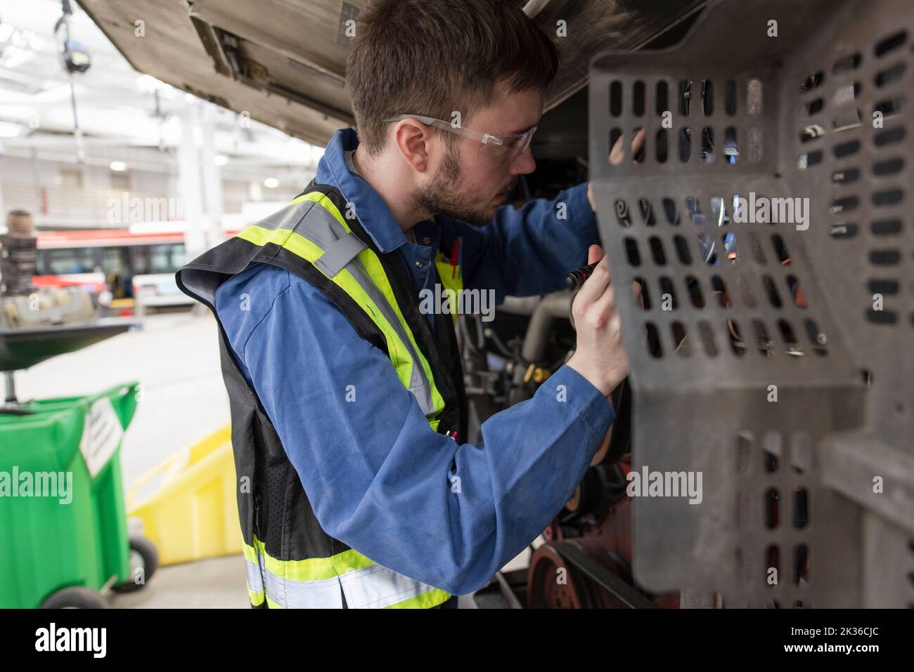Male maintenance facility engineer working under bus Stock Photo Alamy