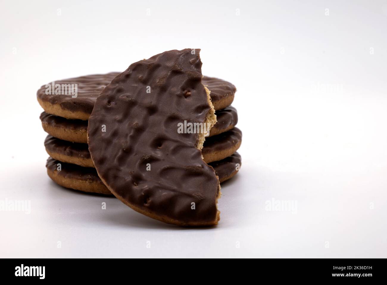 Milk chocolate biscuits a stack and half eaten Stock Photo Alamy