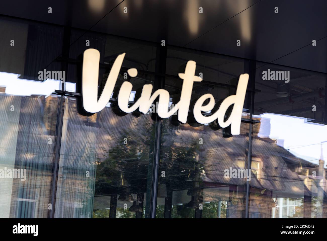 Vinted logo sign on main office, headquarters building wall. Vinted is online marketplace for second hand clothing, Unicorn startup Stock Photo
