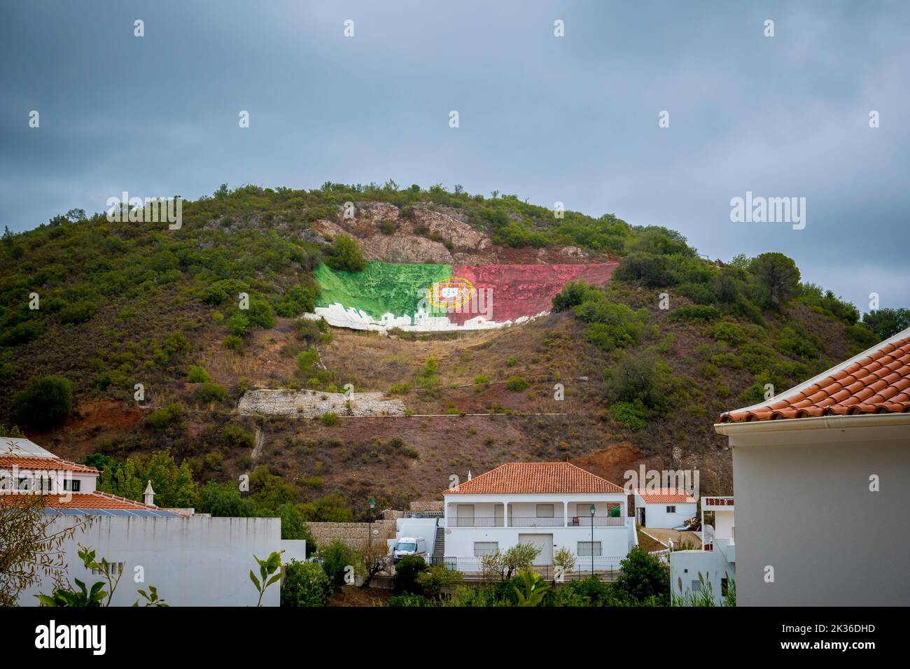 Alte, Portugal, September 2022: Portuguese flag painted on the mountain Stock Photo