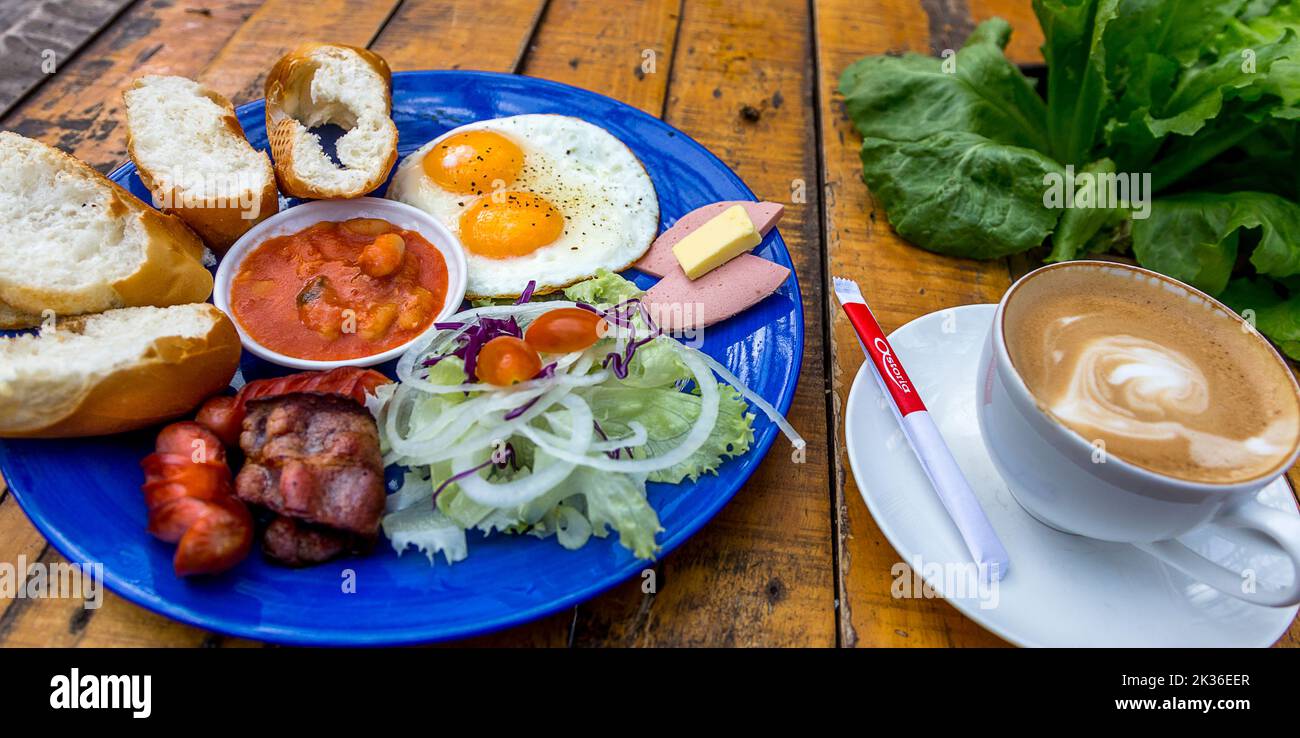 Two eggs sunny-side up with bacon, a full English breakfast served in Da Lat, Vietnam. Stock Photo