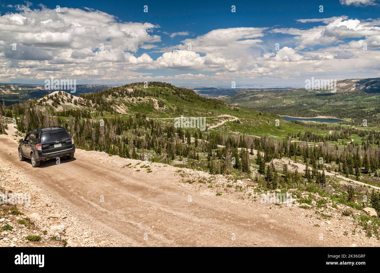 SUV on Skyline Drive III (FR 022), Ferron Reservoir in distance, Wasatch Plateau, Manti La Sal National Forest, near Mayfield, Utah, USA Stock Photo