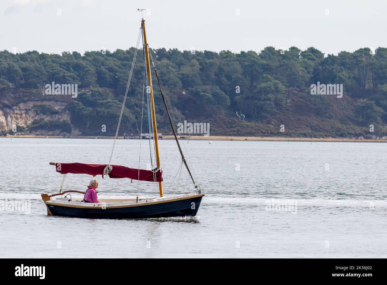 Arne, Dorset, UK - September 20 : View of a yacht passing Arne in Dorset on September 20, 2022. One unidentified person Stock Photo