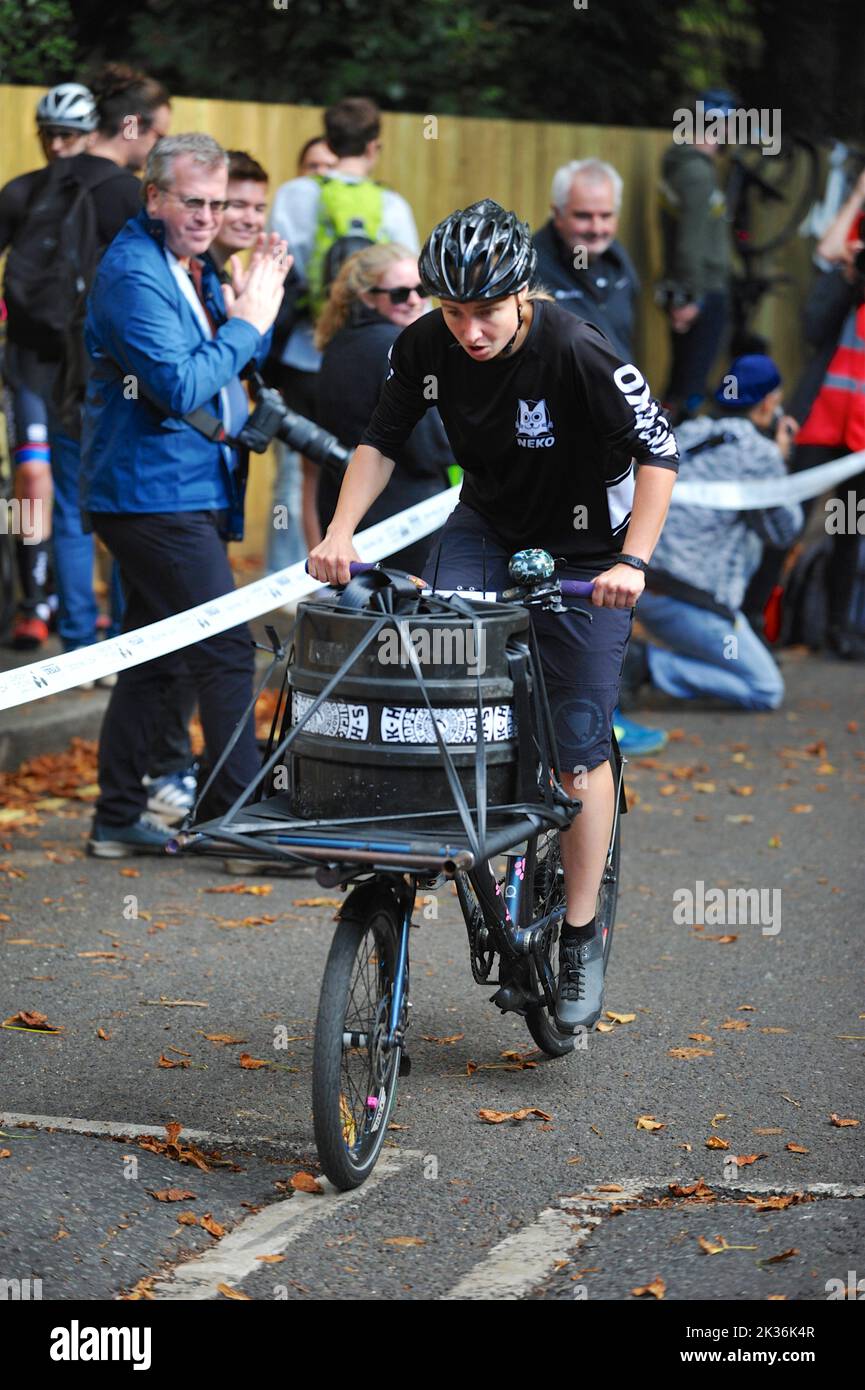 A cyclist straining as they race up Swains Lane in Highgate, London