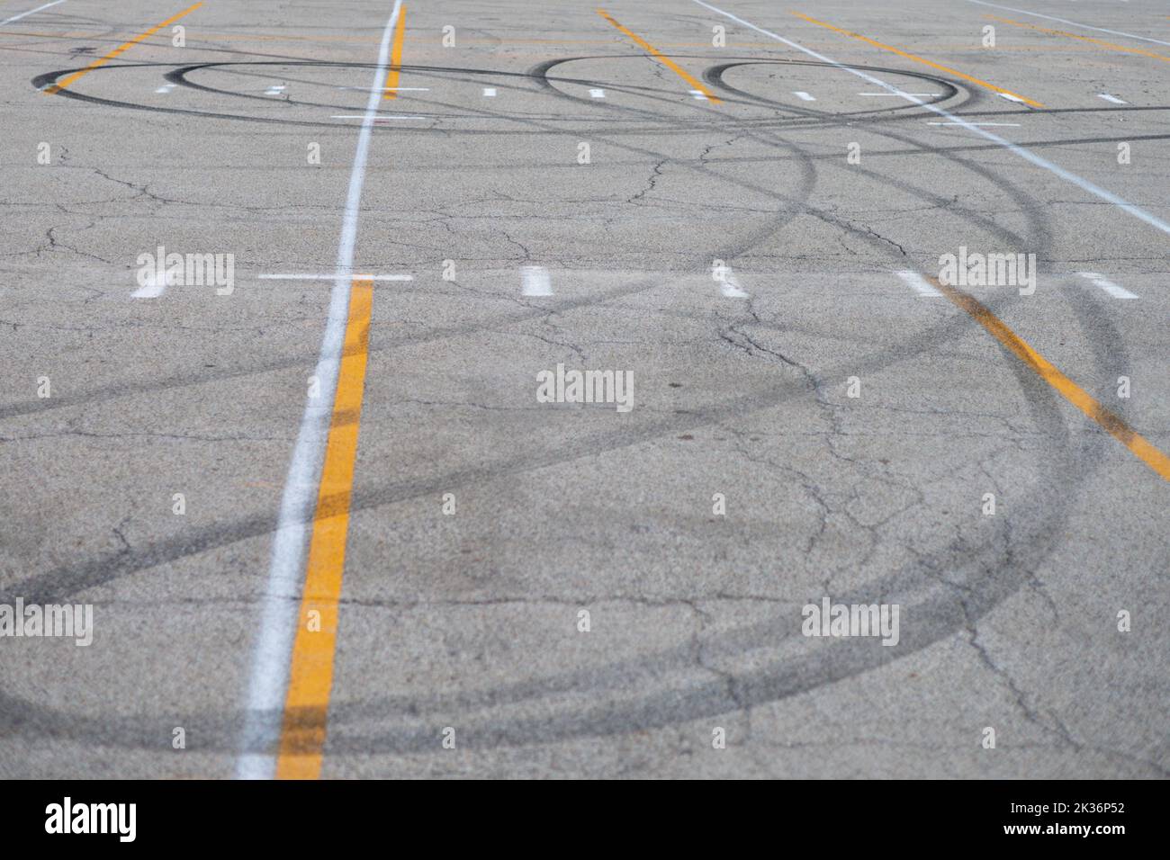 looping car tracks in the middle of a parking lot Stock Photo
