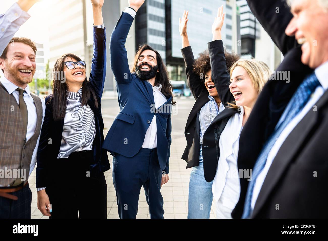 Business team of diverse people celebrating success outside enterprise office Stock Photo