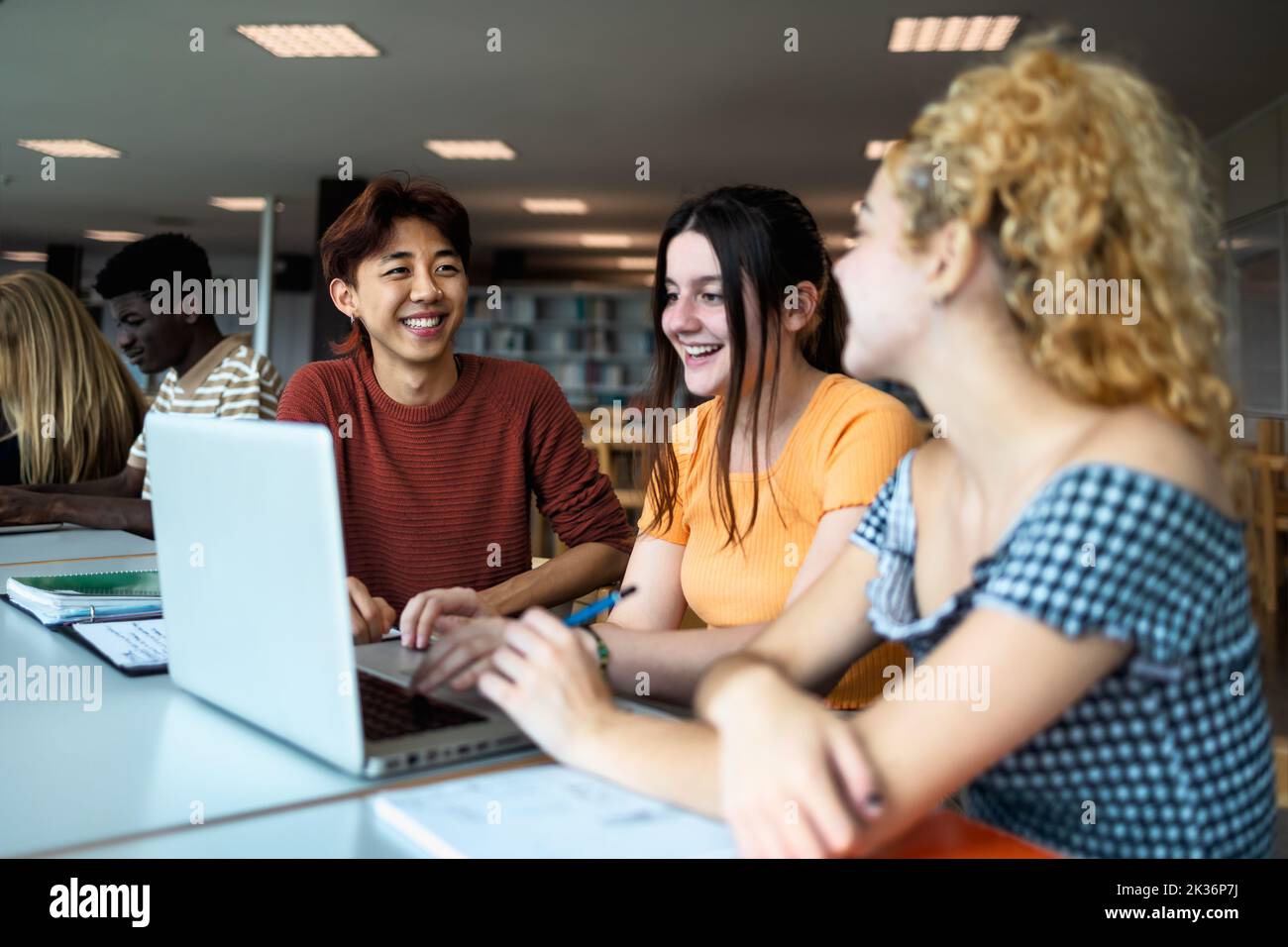 Young multiracial people studying together inside university library - School education concept Stock Photo