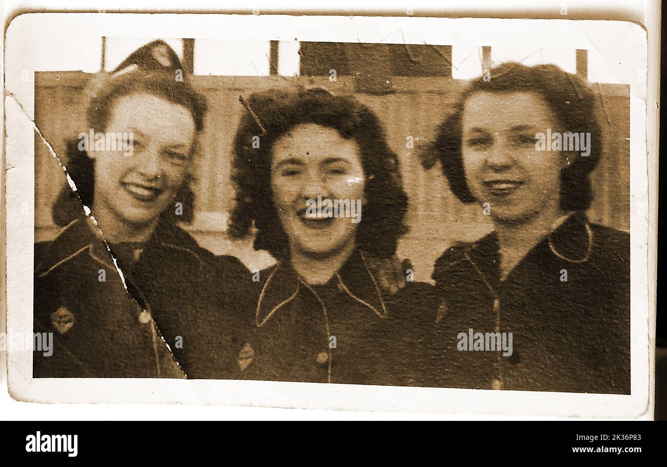 A  vintage photograph  of three  Naafi girls  working at the The Navy, Army and Air Force Institutes (NAAFI) canteen at Catterick, UK. The lady on the left was Miss Rosamund  Waters from Whitby Yorkshire area, other unknown. The modern NAAFI organisation was formed in 1921  By April 1944 it has  7,000 canteens and employed 96,000  as well as controlling  ENSA the forces entertainment group. Stock Photo