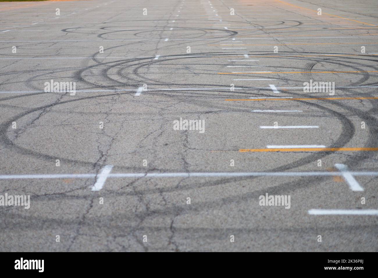circular car tracks in the middle of a parking lot Stock Photo