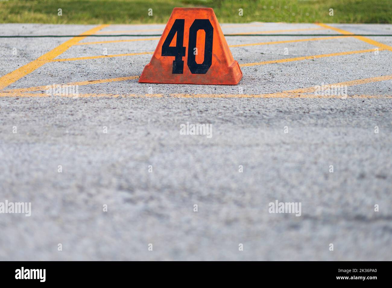 orange forty yard line marker ready for a marching band rehearsal Stock Photo
