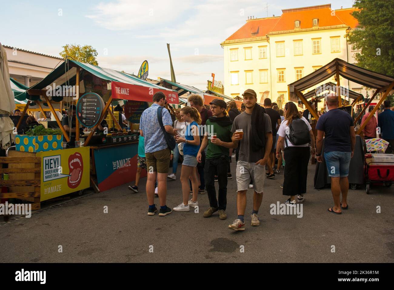 Ljubljana,Slovenia - September 3rd 2022.Tourists and locals enjoy food and drink at an outdoor street food market in Pogacarjev Trg, central Ljubljana Stock Photo