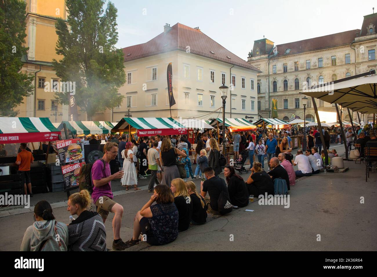 Ljubljana,Slovenia - September 3rd 2022.Tourists and locals enjoy food and drink at an outdoor street food market in Pogacarjev Trg, central Ljubljana Stock Photo