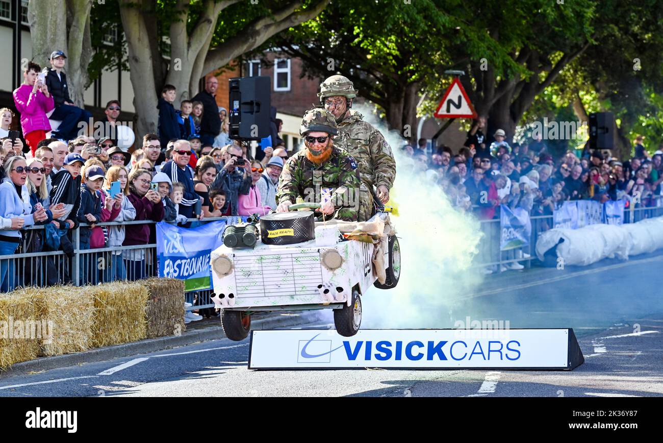 Eastbourne UK 25th September 2022 - These competitors take the final jump in a cloud of smoke as they near the finish in the Eastbourne Seafront Soapbox Race held on the seafront on a beautiful warm sunny day : Credit Simon Dack / Alamy Live News Stock Photo