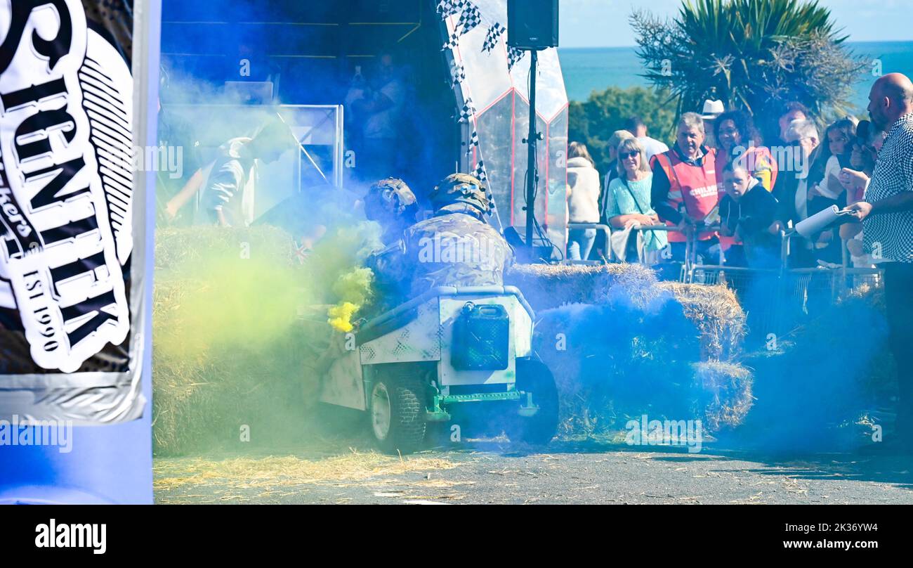 Eastbourne UK 25th September 2022 - These competitors finish  in a cloud of smoke as they reach the finish in the Eastbourne Seafront Soapbox Race held on the seafront on a beautiful warm sunny day : Credit Simon Dack / Alamy Live News Stock Photo