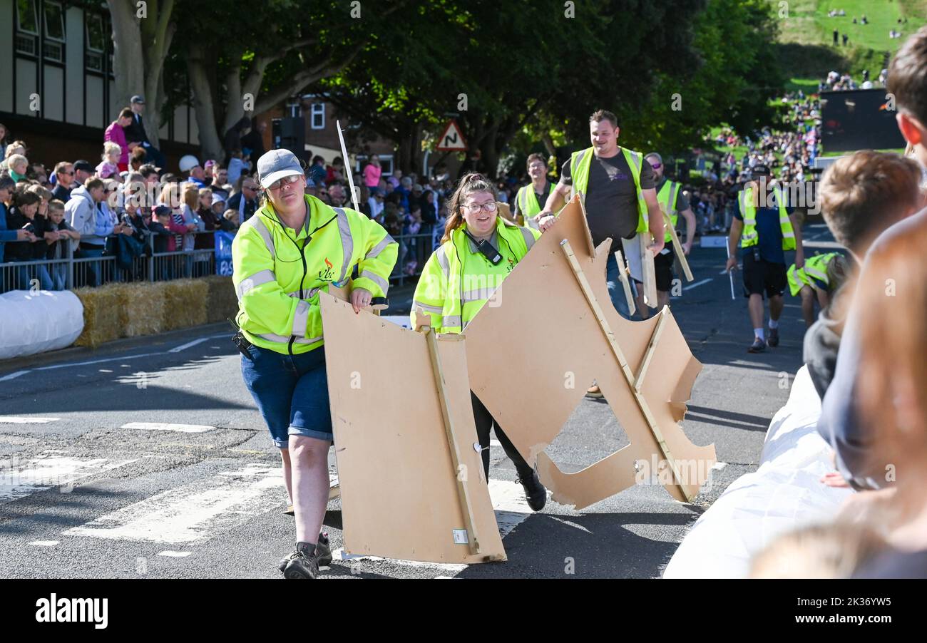 Eastbourne UK 25th September 2022 -Marshalls collect the remnants of a vehicle taking part in the Eastbourne Seafront Soapbox Race held on the seafront on a beautiful warm sunny day : Credit Simon Dack / Alamy Live News Stock Photo