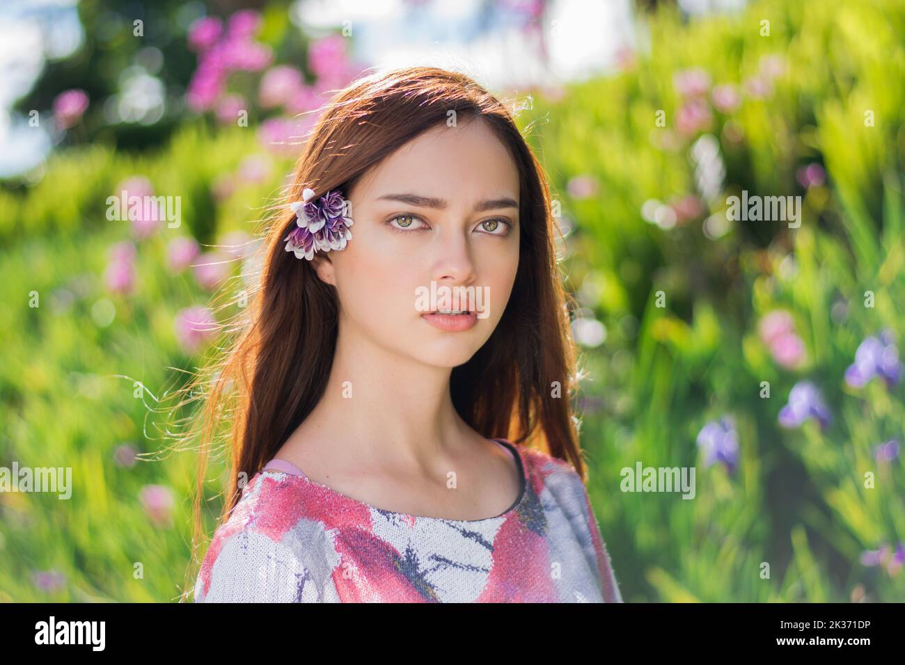 A young beautiful female with a flower in her hair posing on a