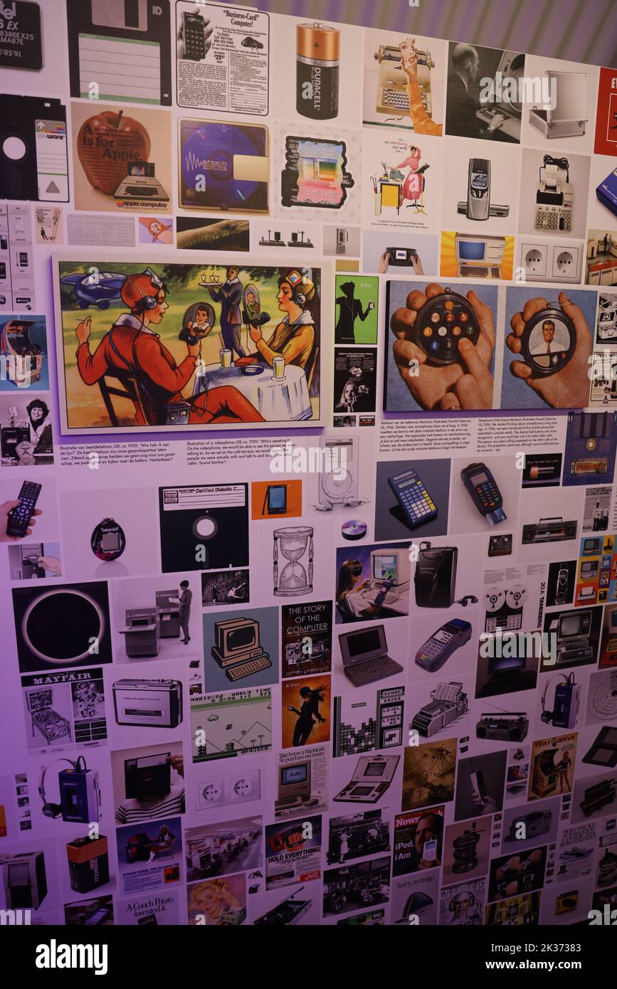 Wall with collection historic advertisements of technological companies and applications, exhibited at the Retrofuture expo in the Evoluon Stock Photo