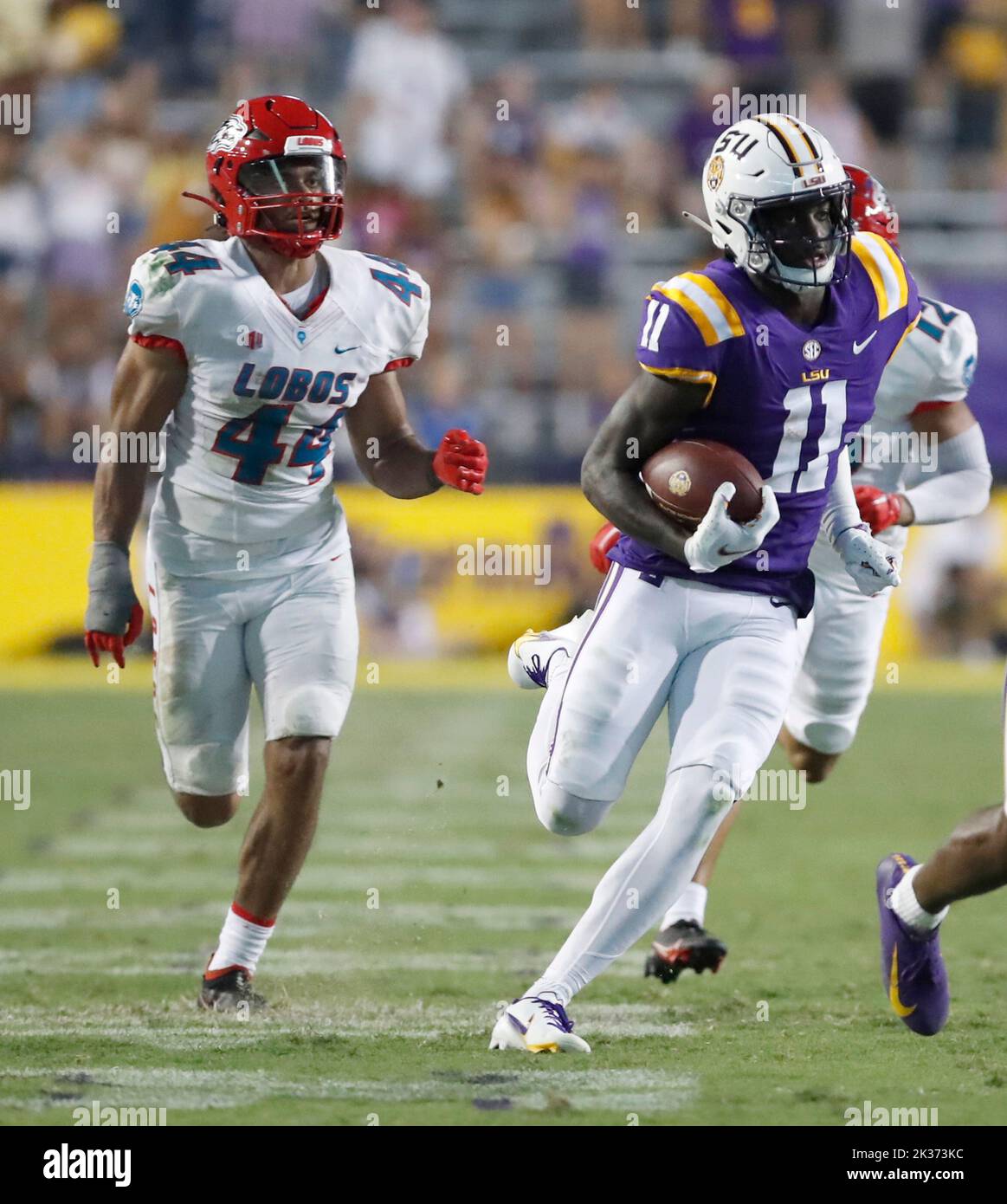 LSU Tigers wide receiver Brian Thomas Jr. (11) runs past New Mexico Lobos linebacker Reco Hannah (44) en route to a 57-yard touchdown catch at the 13:14 mark in the fourth quarter of a college football game at Tiger Stadium in Baton Rouge, Louisiana on Saturday, September 24, 2022.  (Photo by Peter G. Forest/Sipa USA) Stock Photo