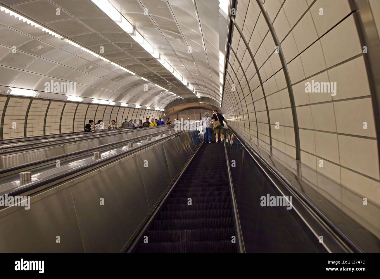 New York, NY, USA - Sept 24, 2022: A long escalator takes passengers 7 stories underground to the 7-train platform at Hudson Yards Stock Photo