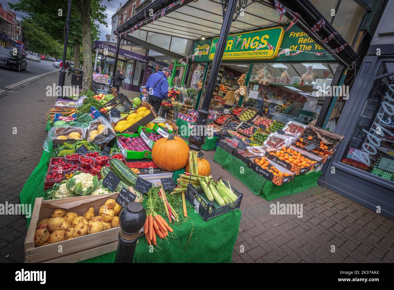 Bright greengrocers pavement display of fruit and vegetabkes  infront of the shop Stock Photo