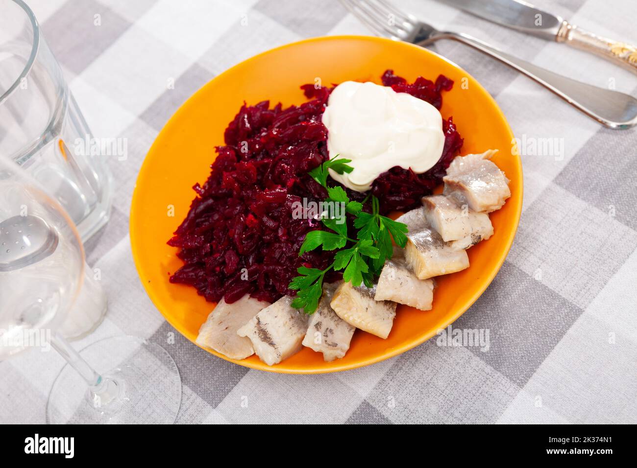 Sliced herring with grated beetroot served on table Stock Photo