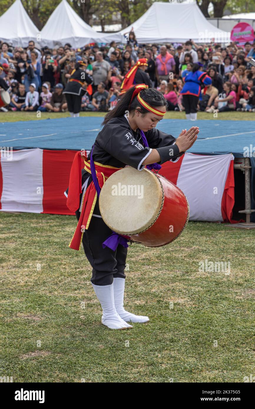 Buenos Aires, Argentina - September 25, 2022: Young Japanese woman doing the sun salutation. Eisa (Japanese dance with drums) in Varela Matsuri. Stock Photo