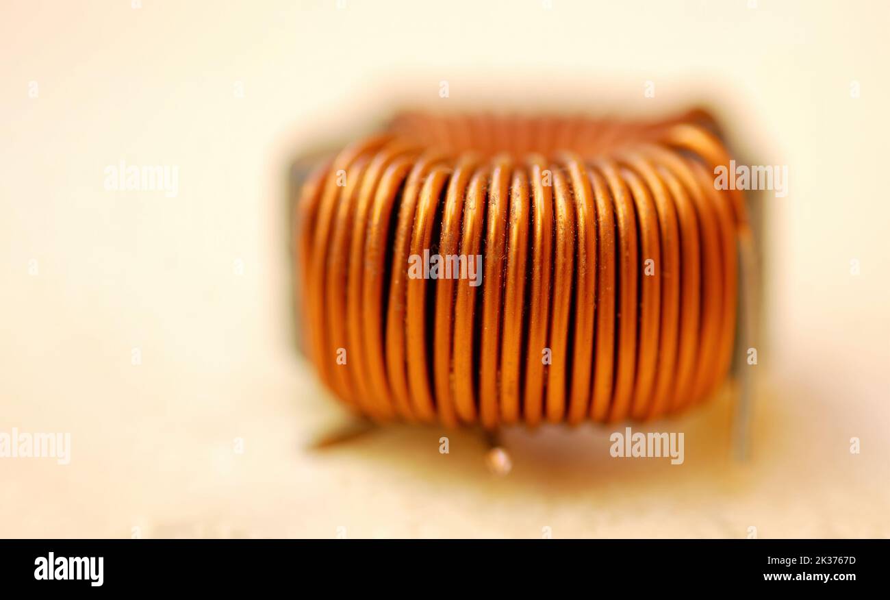 An insulated copper coil, inductive component that stores energy as a magnetic field by induction Stock Photo